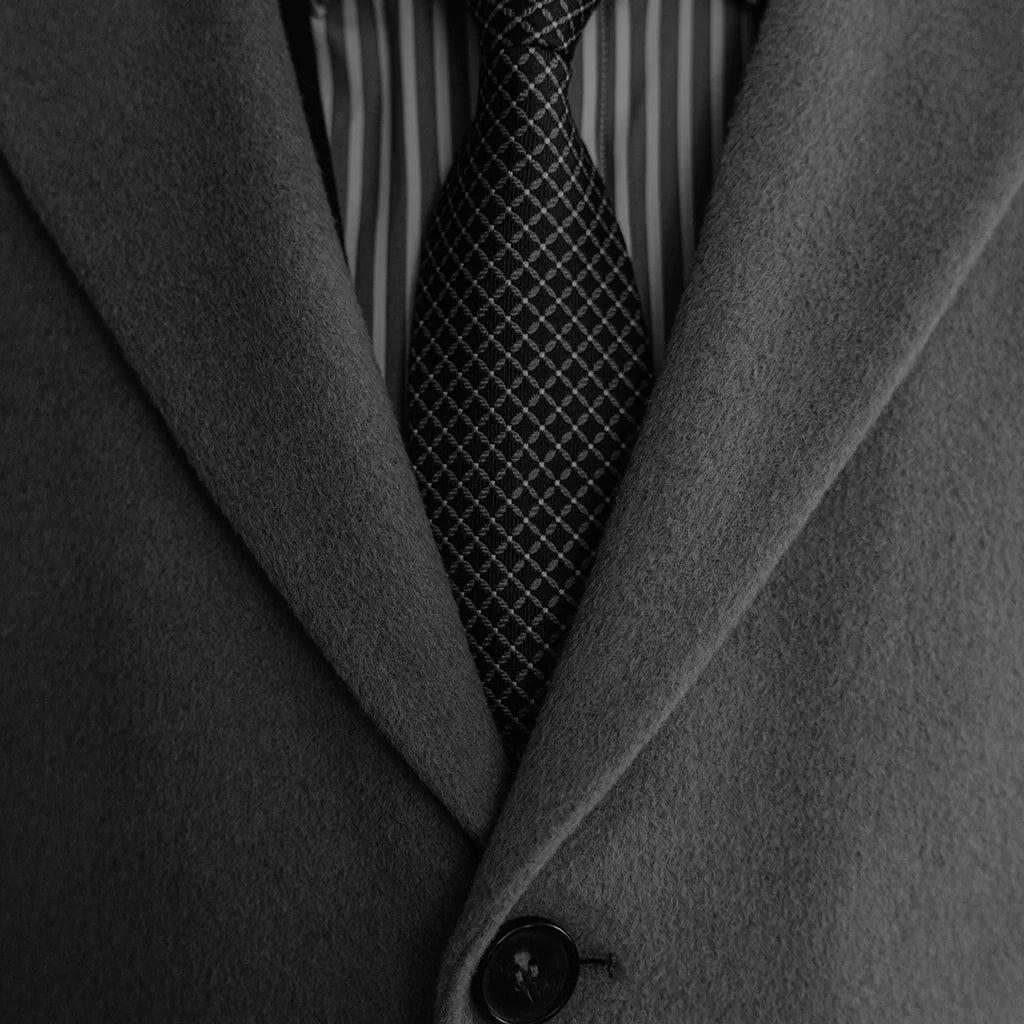 close up of men's formal suit with patterned tie