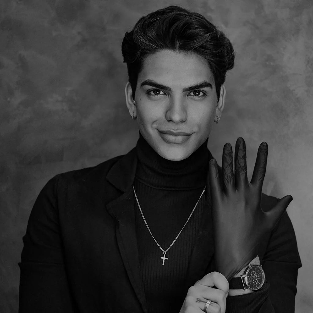 Man wearing fitted designer gloves and layered jewellery from the EDRM Men’s Gloves collection, showcasing premium designer clothes and luxury streetwear UK accessories