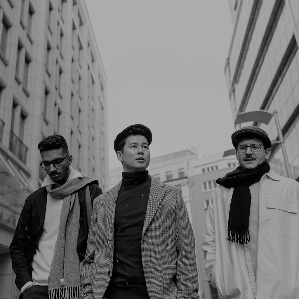 Three men wearing winter outfits and designer scarves from the EDRM Men’s Scarves collection, showcasing premium designer clothes and luxury streetwear UK accessories
